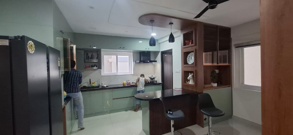 Modern kitchen with custom sage cabinetry and stone counters